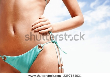 Woman, stomach and bikini in sunshine, blue sky background or freedom for mockup space, holiday or cloud. Girl, hands and swimwear with abdomen, vacation and outdoor in summer for wellness in Spain