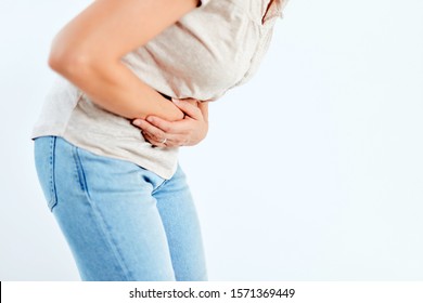 Woman With Stomach/ Hip Issues / Problems On The White Background.