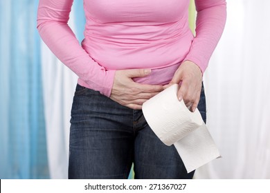 Woman With Stomach Pain And Toilet Paper Roll