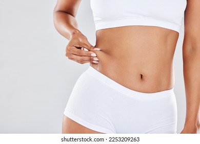 Woman, stomach and weight wellness in lingerie for healthcare, skincare beauty or body training in white background. Model, tummy tuck or gut health for exercise motivation or abdomen nutrition diet