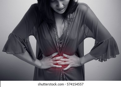 Woman stomachache on a gray background ,Concept with Healthcare And Medicine