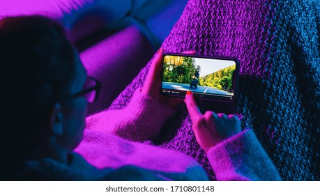 Woman stop watching film on mobile phone with imaginary video player service. Concept of online video streaming movies and series. - Shutterstock ID 1710801148
