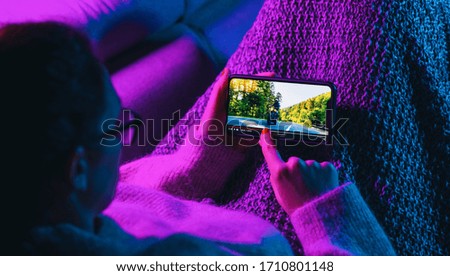 Woman stop watching film on mobile phone with imaginary video player service. Concept of online video streaming movies and series.