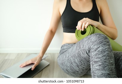 Woman Stop To Work And Workout Or Fitness At Home For Balance Idea. Close Computer Hold Yoga Mat. Balancing Life Concept.