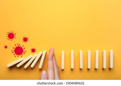 Woman Stopping Domino Effect On Yellow Background, Top View. Prevent Spreading Of Coronavirus