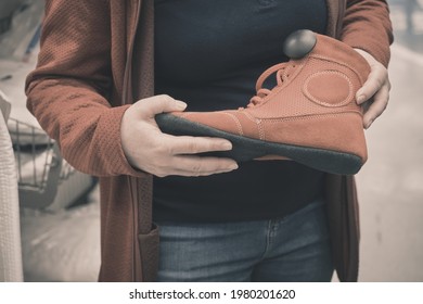 Woman in store chooses to buy red, soft boxing shoes. Concept of women independence, feminism, gender equality and martial arts. Hands close up shot - Powered by Shutterstock