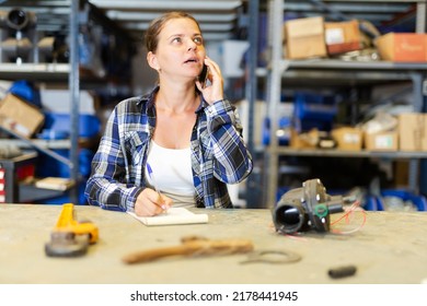 Woman Store Warehouse Employee Talking On Mobile Phone With Customer