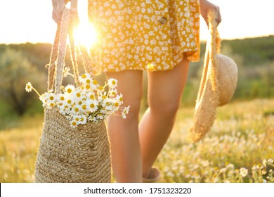 Woman With Straw Hat And Handbag Full Of Chamomiles Walking In Meadow, Closeup
