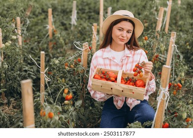 A woman with a straw hat kneels in a lush vegetable garden, joyfully holding a basket full of ripe tomatoes on a sunny day. - Powered by Shutterstock