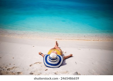 woman with straw hat sunbathing on tropical beach - Powered by Shutterstock