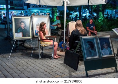 A Woman Street Artist Paints A Portrait Of A Girl. Chaniotis, Greece, 13 June 2022.