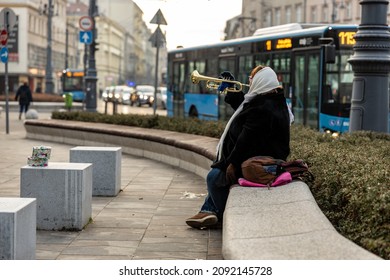 Woman Street Artist Playing The Trumpet In Christmas Time 