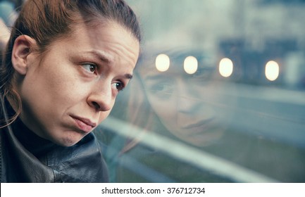 A woman in streetcar alone and annoyed
