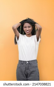 Woman In Stress. Indian South Asian Woman Stressed Is Going Crazy Pulling Her Hair In Frustration And Making Face.