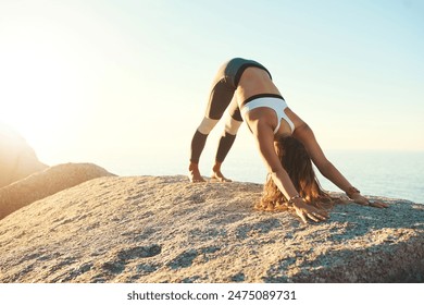 Woman, stretch and yoga wellness or ocean exercise, pilates and relaxing position for body health. Fitness, balance workout and beach for peace outside in nature, vitality and zen activity on rock - Powered by Shutterstock