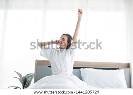 Woman stretching after waking up in the morning. Beautiful women wake up with a refreshing.