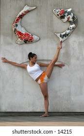 woman stretching against wall