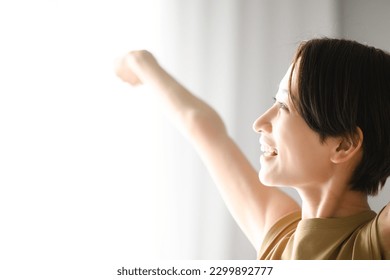 Woman stretching because the morning sun feels good Up Copy space - Shutterstock ID 2299892777