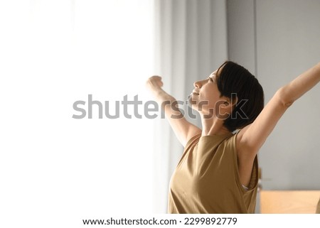 Woman stretching because the morning sun feels good Up Copy space