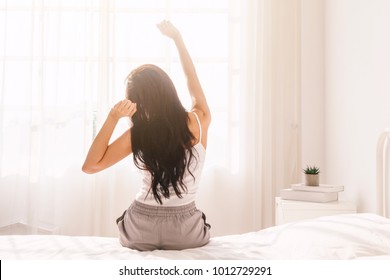 Woman Stretching In Bed After Wake Up