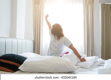 Woman Stretching In Bed After Wake Up