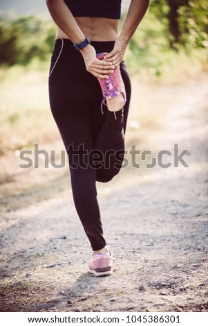 Similar – Woman in sports wear with earphones looking smartphone