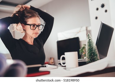 Woman Stretching Her Back At Desk In Home Office