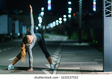 Woman Stretching, Late Night Training in the City - Powered by Shutterstock