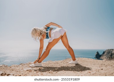 Woman Stretching on a Clifftop Overlooking the Ocean - Powered by Shutterstock