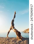 Woman, stretching and pilates fitness or beach exercise, yoga and standing splits position for body health. Wellness, balance workout and seaside for peace outside in nature, vitality and zen on rock