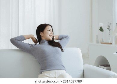 woman stretching relax. She is relaxing on the sofa in the living room on vacation. She does yoga poses to relax after a hard day's work. The idea of taking a break from hard work. - Powered by Shutterstock