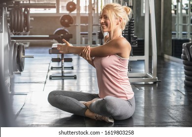 Woman Stretching Shoulders Muscle Before Workout In Gym.