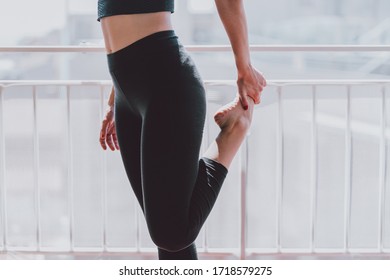 Woman Stretching And Warming Up Her Legs Before Starting Exercise At Home
