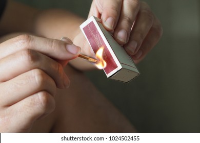Woman striking a match - Powered by Shutterstock