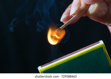 Woman Striking A Match And Make A Fire