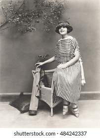 Woman in striped dress with golf clubs