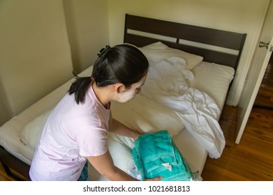 Woman Stripped Bed Linen For Cleaning House 