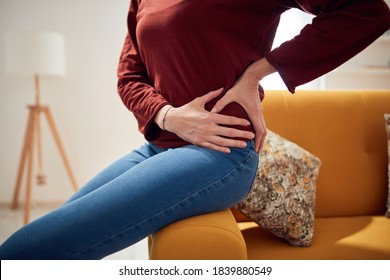 Woman With Strong Hip Pain At Home.