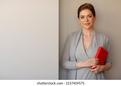 Woman Student Or Teacher Holding Red Book.