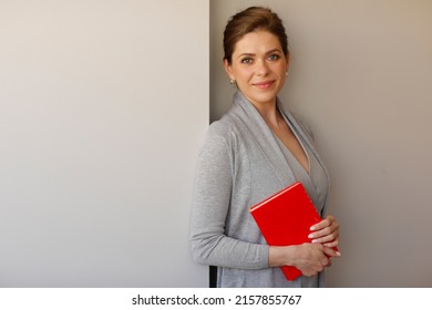 Woman Student Or Teacher Holding Red Book.