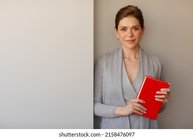 Woman Student Or Teacher Holding Red Book.