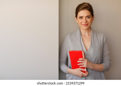 Woman Student Or Teacher Holding Red Book.