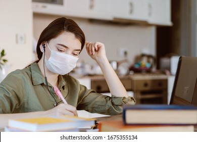 Woman Study At Home With Medical Mask On Face. Coronavirus Quarantine Remote Student Online Home Education Concept.