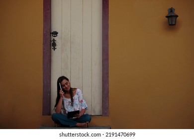 Woman Studying Or Working With A Tablet Computer Outdoors And Happy	