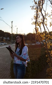 Woman Studying Or Working With A Tablet Computer Outdoors And Happy	