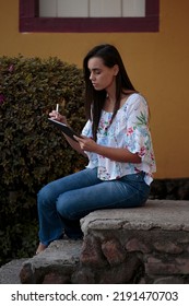 Woman Studying Or Working With A Tablet Computer Outdoors And Happy	