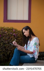 Woman Studying Or Working With A Tablet Computer Outdoors And Happy	