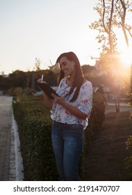 Woman Studying Or Working With A Tablet Computer Outdoors And Happy	