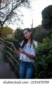 Woman Studying Or Working With A Tablet Computer Outdoors And Happy	