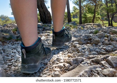 Woman in sturdy hiking shoes on technical trail close up